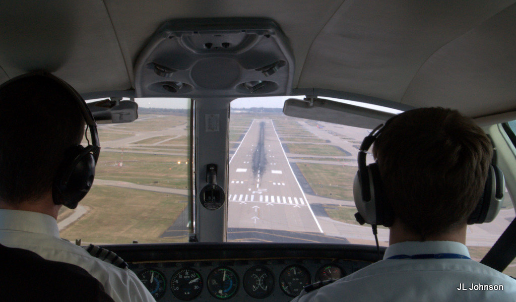 A light aircraft climbing out on a go-around from short final approach